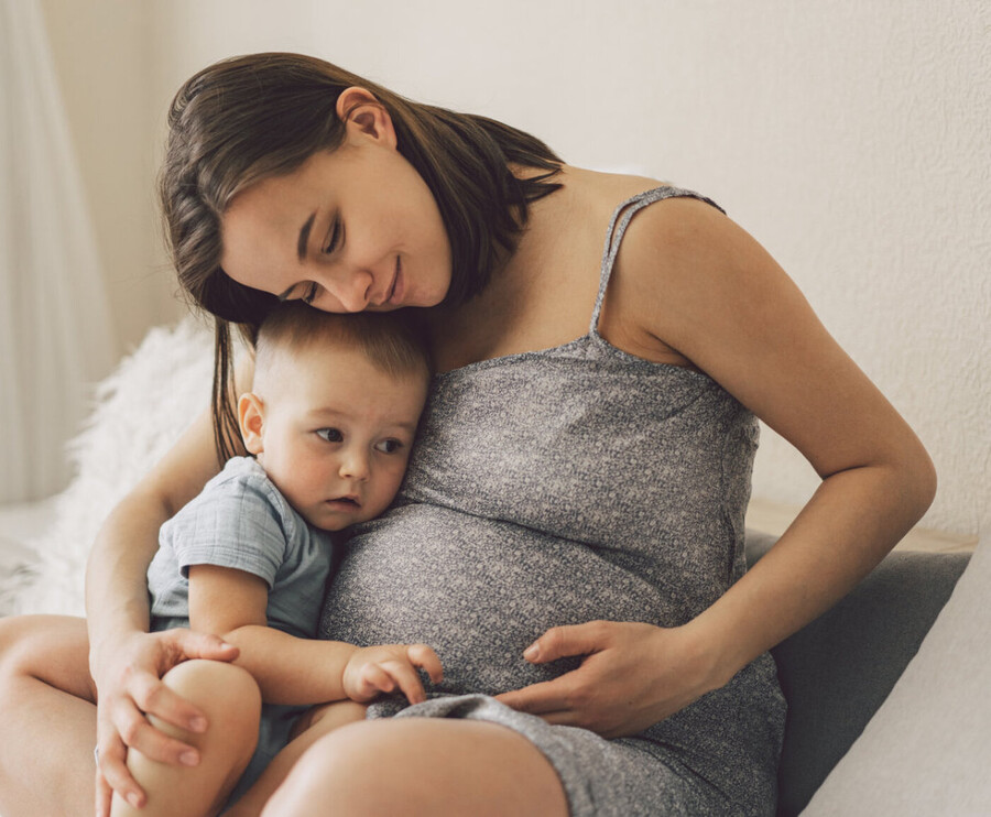 Young pregnant woman with toddler