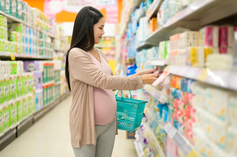 pregnant woman in store looking at products